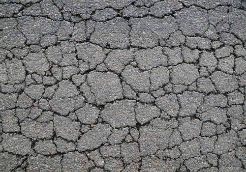 Macro closeup on concrete asphalt cracks on the road