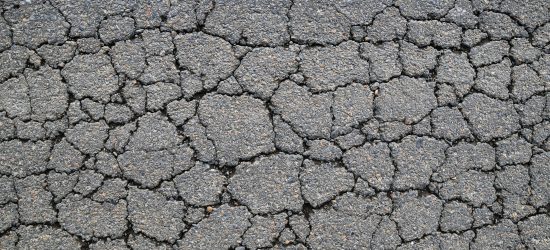 Macro closeup on concrete asphalt cracks on the road